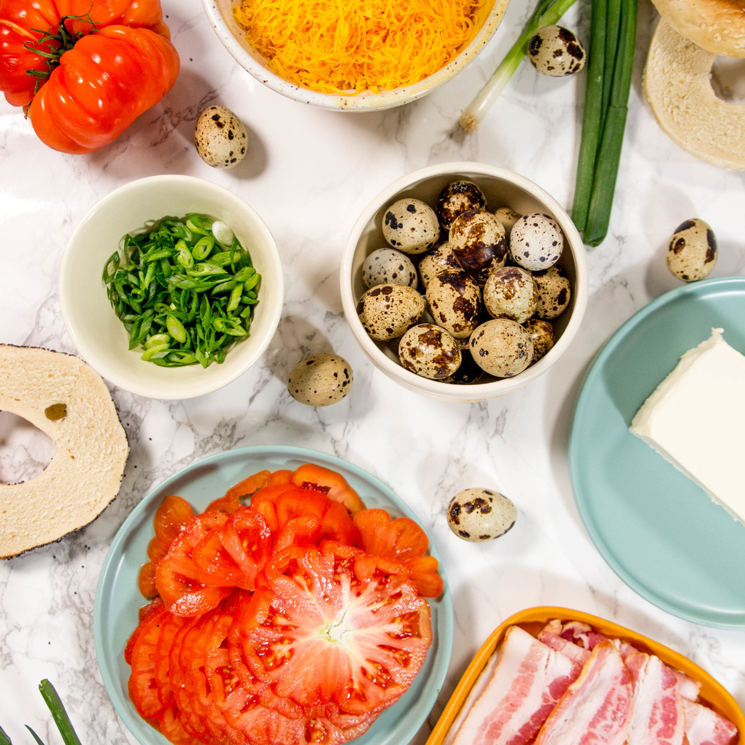 tomatoes, quail eggs, bacon in bowls